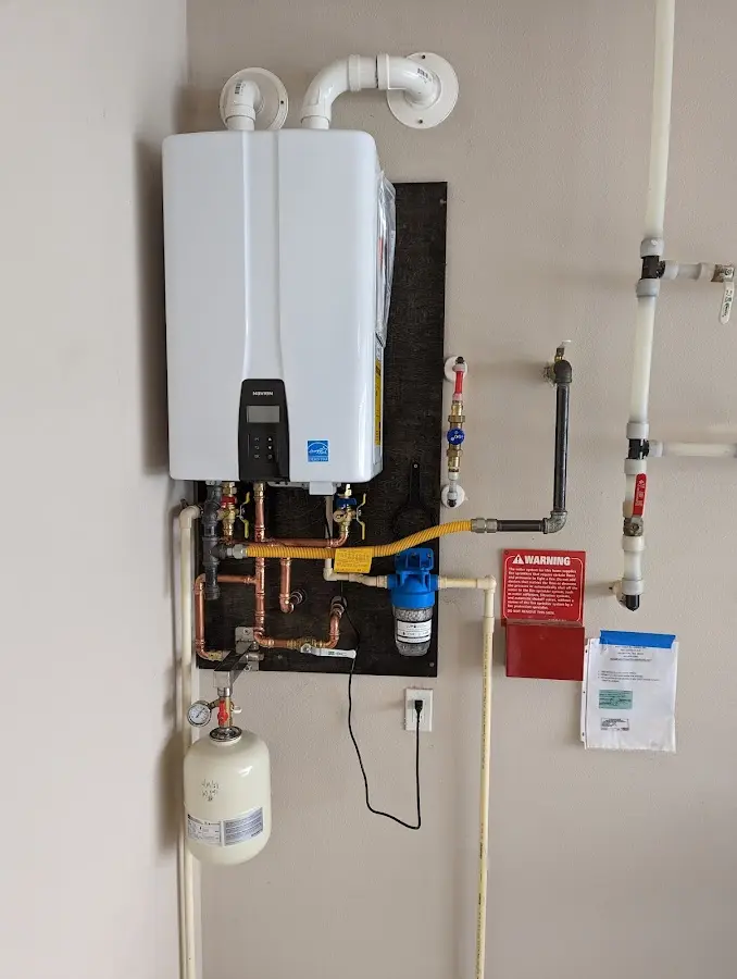 Professional plumber installing copper piping in a Fox home